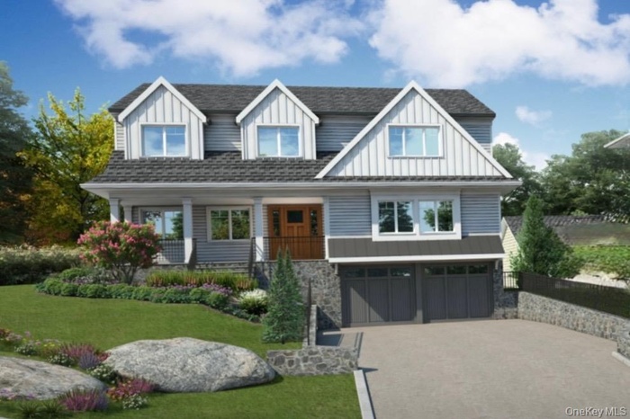 View of front of property with a front yard, a porch, board and batten siding, and driveway