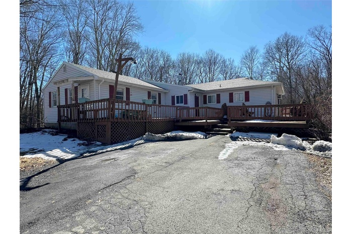 View of front of house with a wooden deck