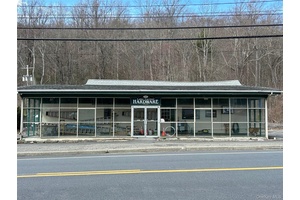 THREE Commercial Buildings with one of them containing a one bedroom Residential unit.