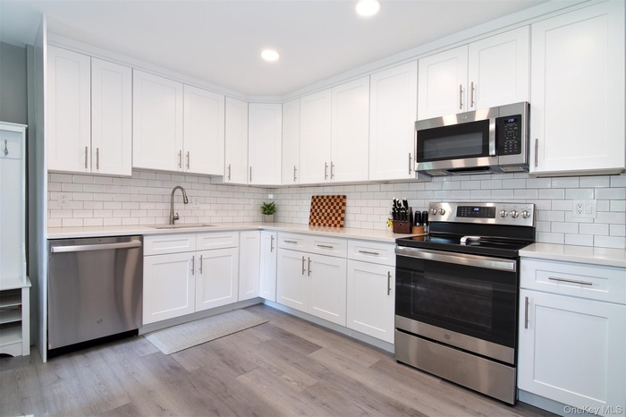 Huge kitchen w stainless steel appliances and granite countertops