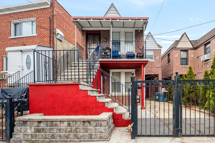 Multi unit property featuring brick siding, a fenced front yard, a gate, and a porch