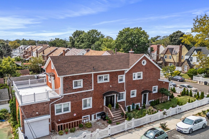 View of front of home with a residential view, a fenced front yard, and brick siding