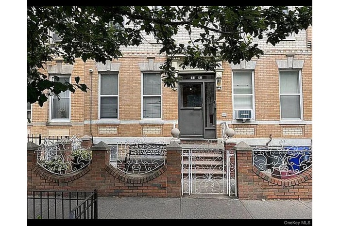Entrance to property with brick siding and a gate