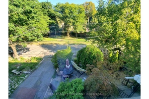 Facing a garden amp ; Parkette And A Hill Of Trees In A Quiet Enclave On A Wide Dead End Street.