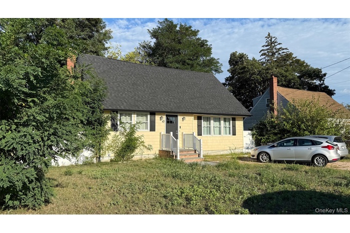 Cape cod home featuring a chimney, roof with shingles, and a front lawn
