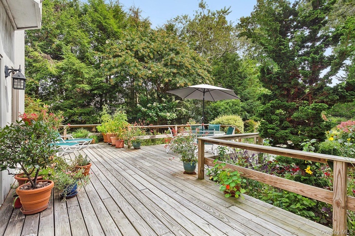 Wooden deck featuring view of scattered trees