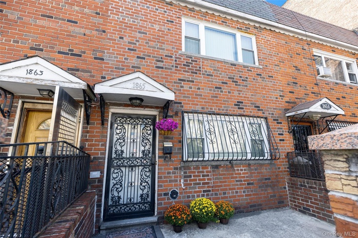 Property entrance with brick siding and a high end roof