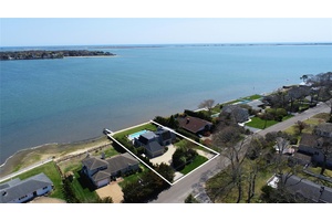 Nestled along Tiana Bay, this exceptional waterfront property in Hampton Bays offers the ultimate summer retreat with breathtaking open water views.