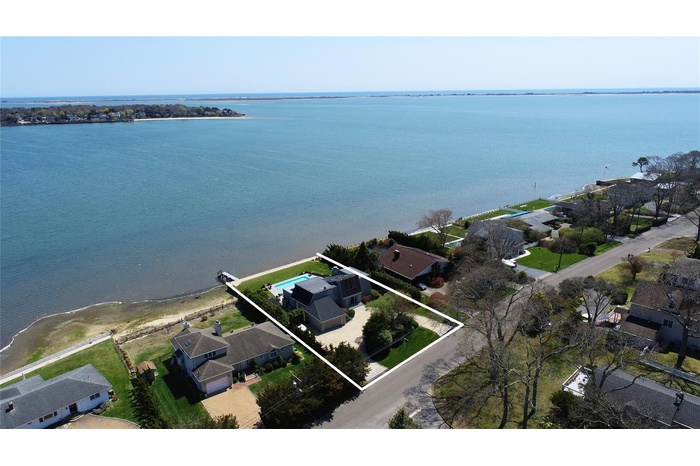 View of property location with nearby suburban area, property parcel outlined, and a large body of water