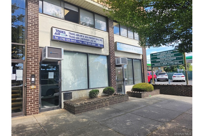 View of commercial property featuring an AC wall unit