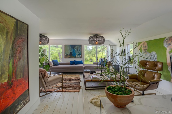 Living room with plenty of natural light and light wood-style flooring