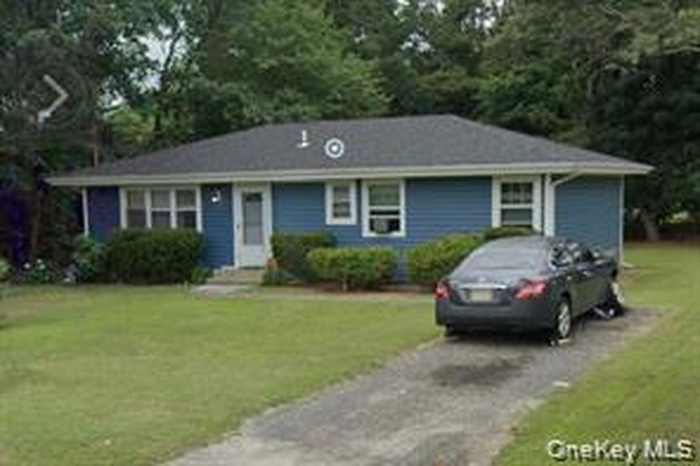 View of front of property with a front lawn and driveway