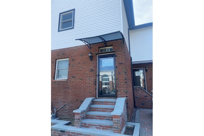 Entrance to property with brick siding