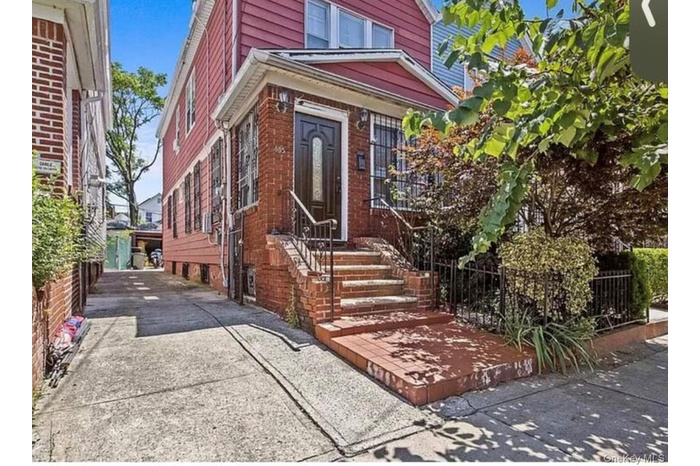 View of exterior entry with brick siding