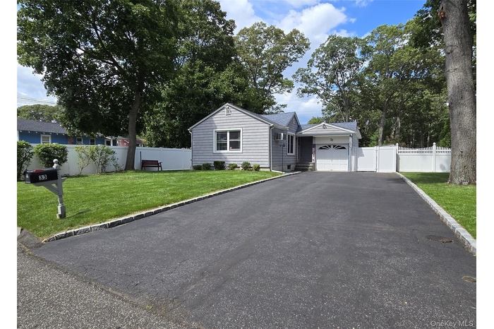 View of front of home with asphalt driveway and an attached garage