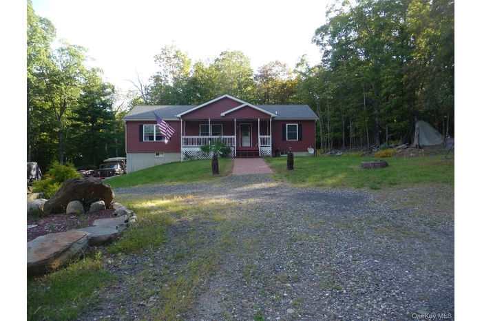 View of front facade featuring a porch and a front lawn