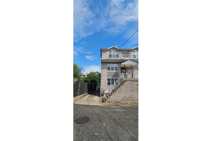 Rear view of property with a fenced front yard and stairs