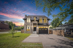 Stunning custom built home with 5, 115 sq ft, featuring a blend of brick, stone, and stucco.