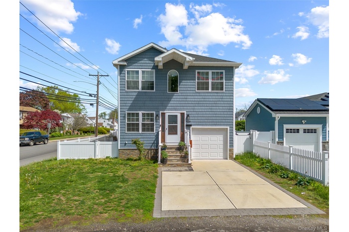 View of front of house with an attached garage and concrete driveway