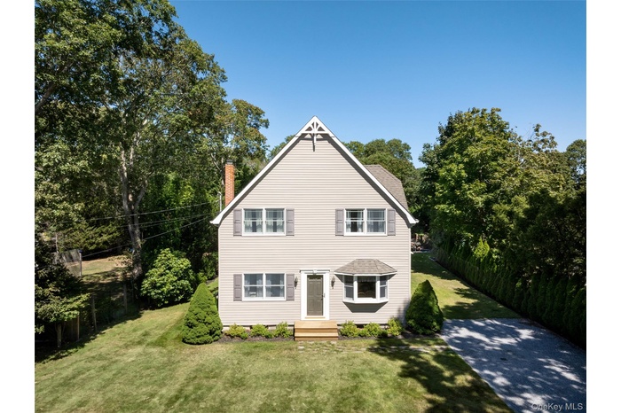Traditional-style house with a front lawn, a chimney, and crawl space