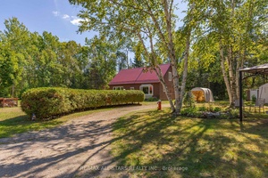 Step into this inviting 3 bedroom, 1 bathroom, open concept home, where vaulted ceilings and sun filled windows frame a cozy wood stove at the heart of the living space.