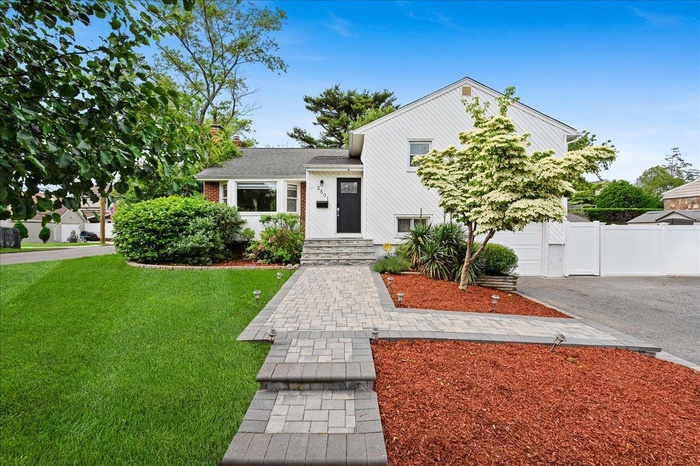 Tri-level home featuring driveway and a garage