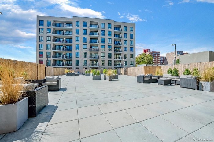 View of property's community with outdoor lounge area and a patio area