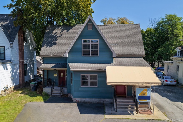View of front facade with a shingled roof