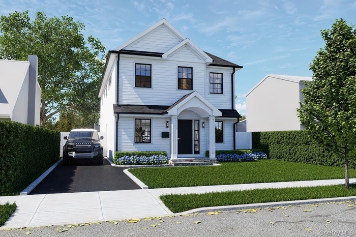 View of front of house with asphalt driveway