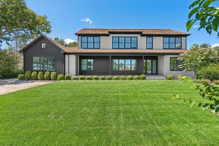 View of front of home featuring a front yard and a porch
