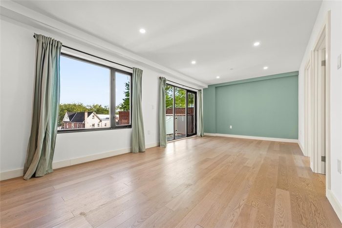 Unfurnished room featuring recessed lighting, light wood finished floors, and baseboards