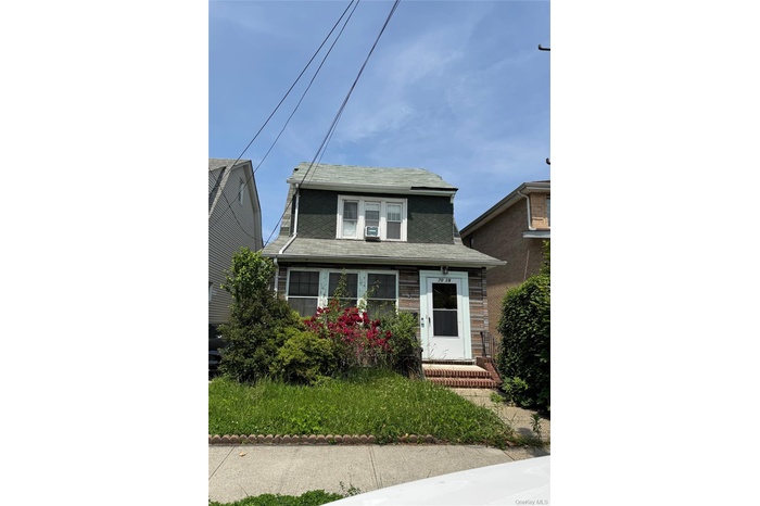 View of front of home with a shingled roof