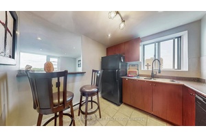 Affordable CORNER CONDO Family size KITCHEN WITH A WINDOW, lots of cupboards, counter space, extra electrical outlets for all your kitchen processors and a breakfast bar overlooking the living room ...