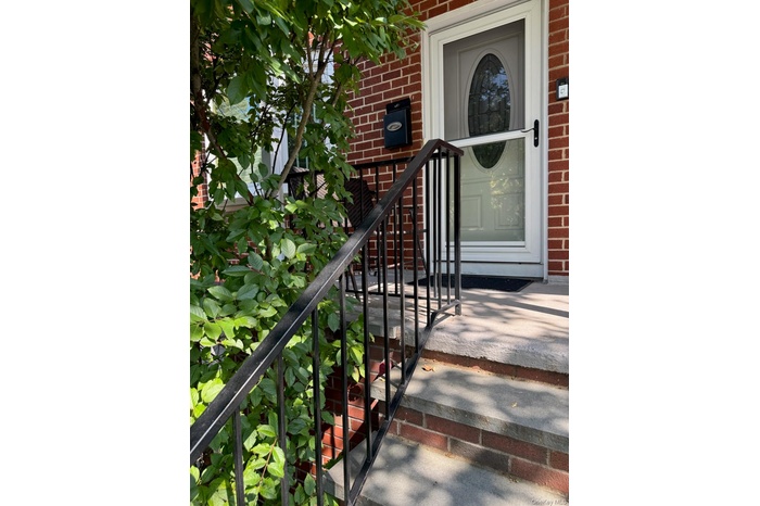 Property entrance featuring brick siding