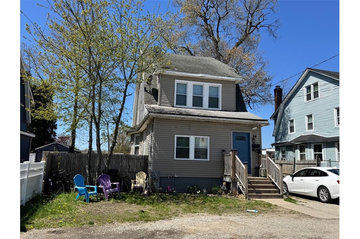 View of front of house featuring a shingled roof