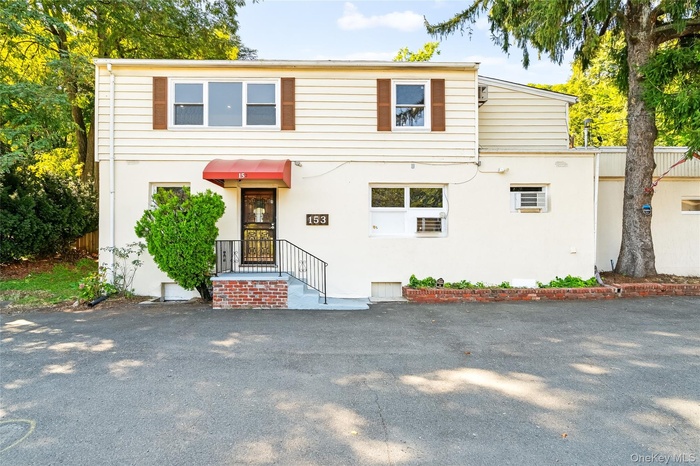 View of front facade featuring stucco siding
