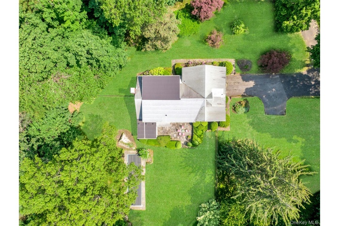 Aerial view of this rare 2.6-acre level property at the end of a quiet cul-de-sac, offering unmatched privacy and endless potential to create the esta
