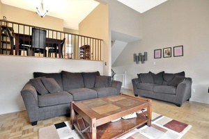 This spacious and charming home features a large living room with soaring ceilings, creating a grand atmosphere.