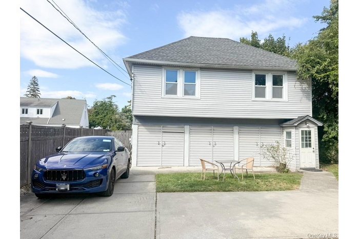 Rear view of house with roof with shingles