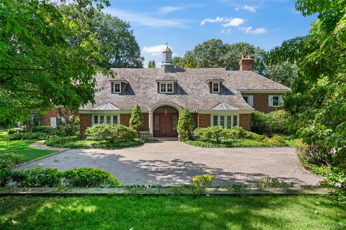 View of front facade with brick siding and a front lawn