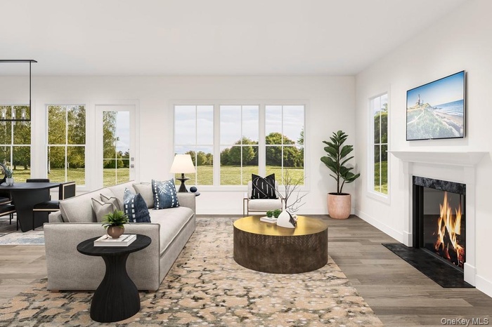 Living area with wood finished floors, a fireplace, and baseboards