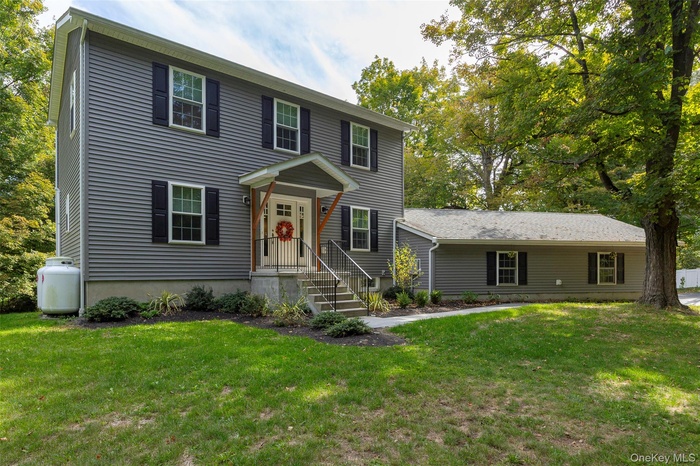 Colonial home with a front yard
