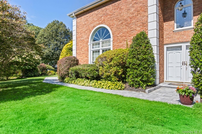 View of home's exterior with a yard and brick siding