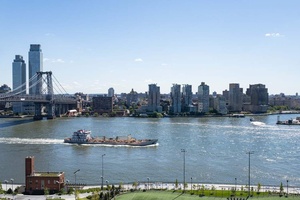 Located on a high floor, this bright and airy two bedroom apartment boasts sweeping views of the NYC skyline, East River, and iconic bridges.