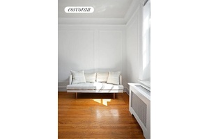 A bright studio with open city views from multiple exposures.