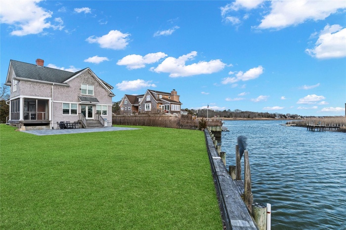 View of deepwater dock with a water view, entry steps, and  super spacious yard