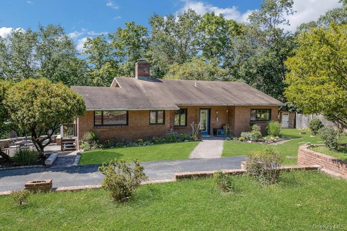 This tucked away, 1960 contemporary ranch sits at the very end of a private gravel road and offers a life of tranquility and serenity surrounded by th