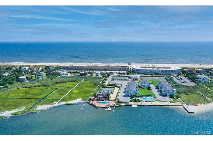 Aerial view of property and surrounding area with expansive coastline and property boundaries highlighted
