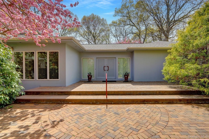 Property entrance with a patio area