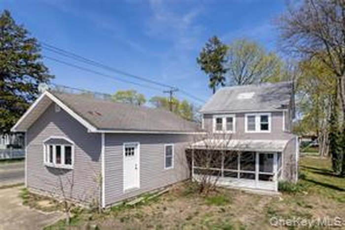 Rear view of house with a sunroom